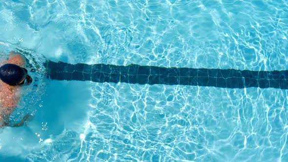 Male swimmer swimming inside pool 4k