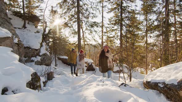 People Walking In Winter Forest