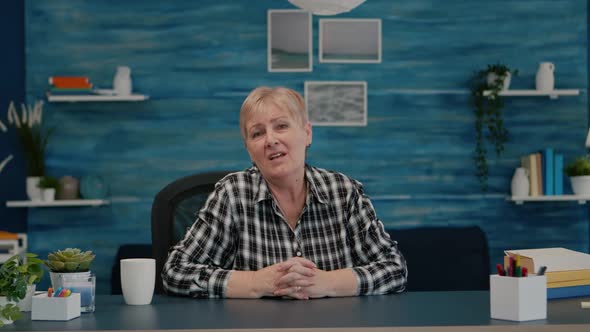 POV of Elderly Aged Woman Waving During a Video Conference