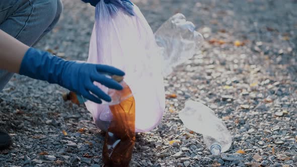 Two Volunteers Collecting Trash in the Community Park As a Weekend Activity