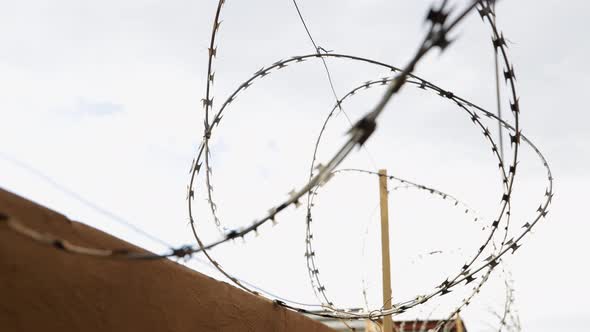 time lapse of clouds with barbed wire in the foreground