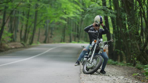 Man gets on motorcycle and rides away