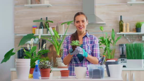 Portrait of Happy Woman Holding Plant