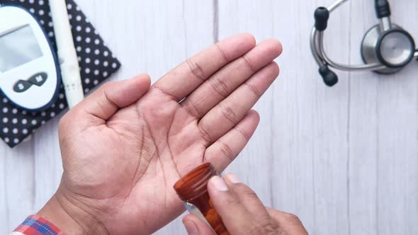 Close Up of Man Hand Taking Medicine 