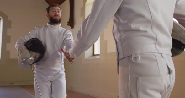 Fencer athletes during a fencing training in a gym