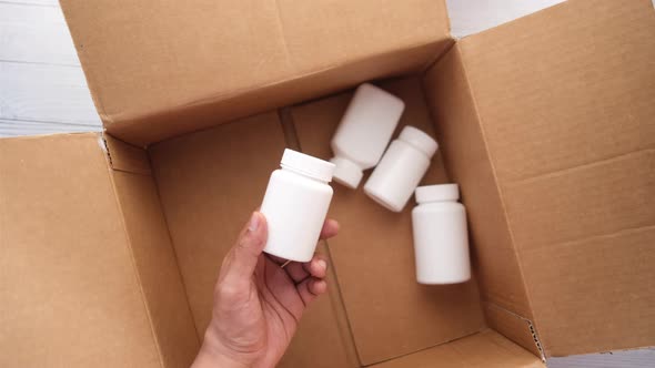 Young Man Hand Holding Many Medicine Pill Container White Sited