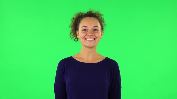 Portrait of Curly Woman Smiling, Revealing Teeth. Green Screen