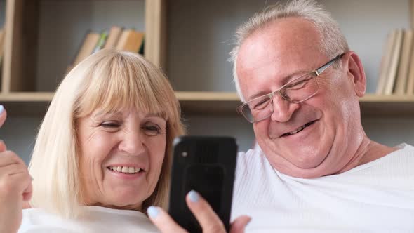 Happy Family of Senior Couple Having Fun Taking Selfie Photo Together on Smartphone