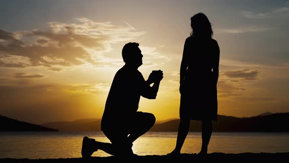 Romantic Silhouettes of a Man Who Offers to Marry a Woman