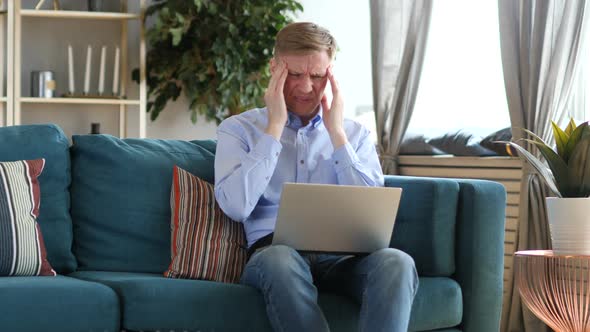 Headache Tired Middle Aged Man Working on Laptop