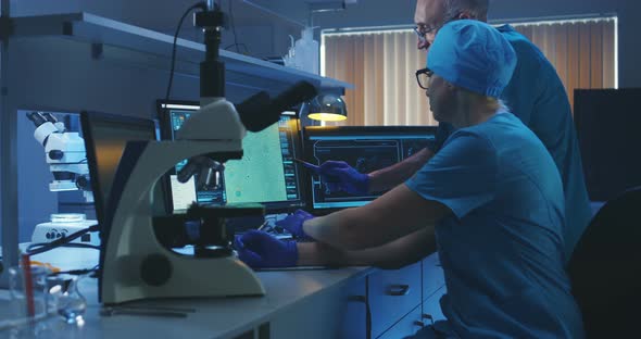 Scientists Examining Bacteria with Microscope