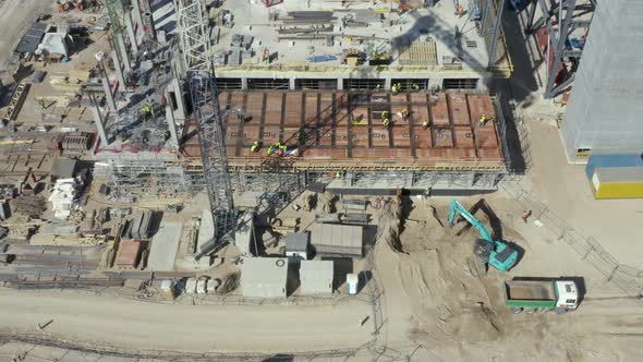 Construction Site with Crowd of Builders and Building Machinery 