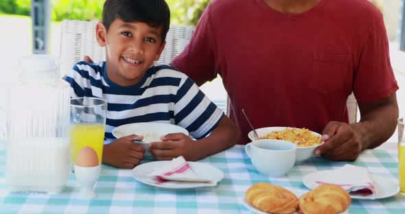 Happy father and son having breakfast 4k