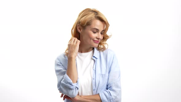 Pretty Shy Woman Feel Flirty Curling Her Hair on Finger Beauty