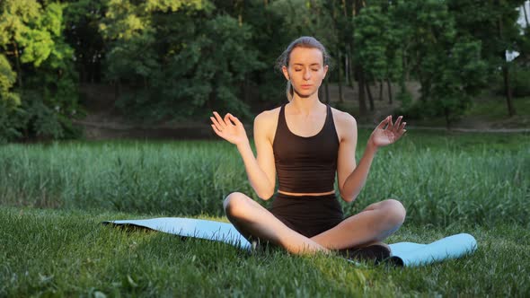 Beautiful Woman Practices Yoga Meditates Lotus Position City Park Green Trees