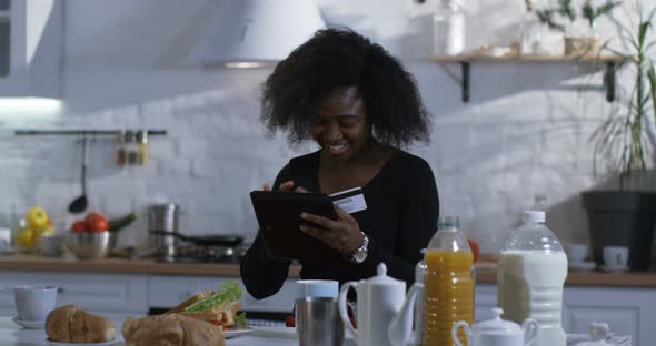 Woman Using Her Tablet in the Kitchen