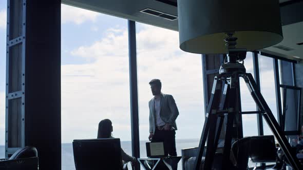 Business Team Silhouettes Talking at Sea Clouds View