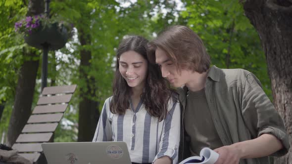 Portrait Happy Couple Spending Time Together in the Park, Studying