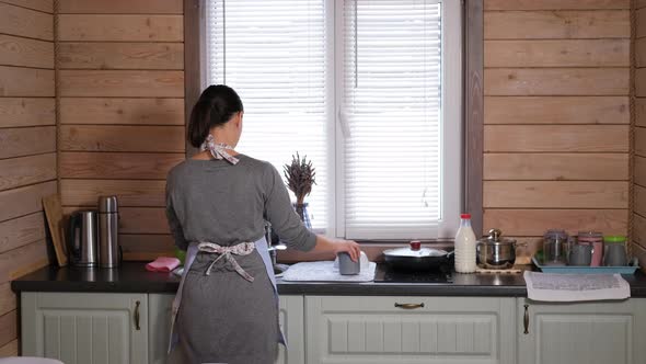 Housewife is Washing Dishes in the Kitchen