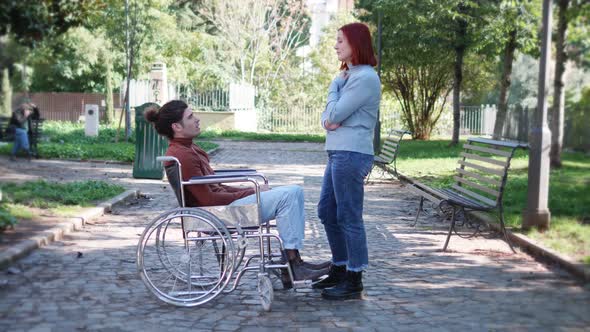 love in wheelchair-man with paraplegia in tender attitude with his girlfriend