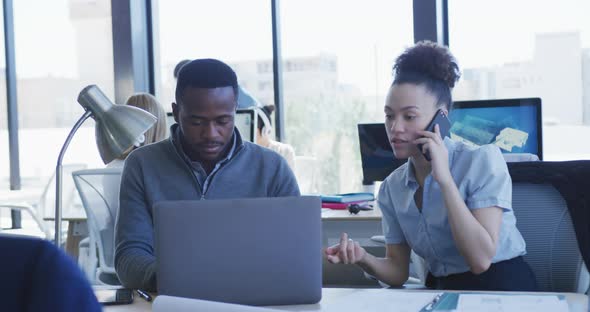 Young man and woman working on computer