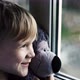 Little Boy Smiling Looking Out the Window Child Looks Out the Window on a Rainy Day - VideoHive Item for Sale