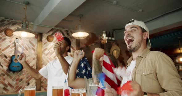 Fans Watching Football in a Bar with Friends