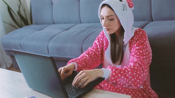 Young Woman in Funny Pajama Working From Home