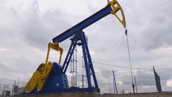 Industrial Oil Well Pumpjack Working and Pumping Crude Oil with Drilling Rig