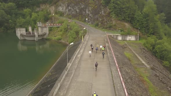 Aerial view of a group of ciclyst during Tura Cu Copaci bike race in Colibita, Romania with drone fl