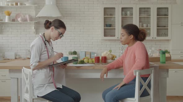 Female Nutritionist Meeting Patient in the Kitchen