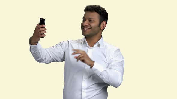 Smiling Young Man Taking Selfie with Mobile Phone