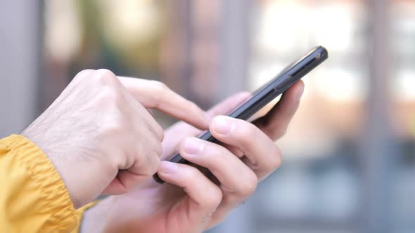 Outdoor Close Up of Hand Using Smartphone