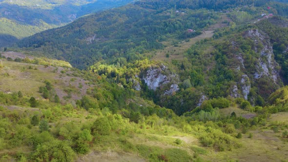 Steep green mountains, deep forest and mountain road, beautiful valley  