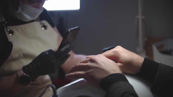 Male Manicure  Woman Takes Photo Hand Her Client