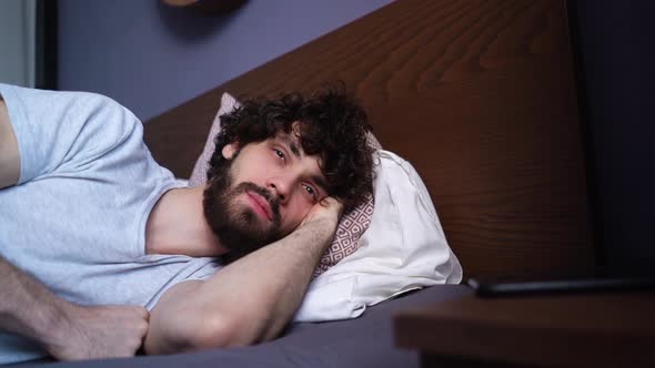 Closeup Face of Sleeping Young Man Opening Eyes Waking Up and Happy Looking Away