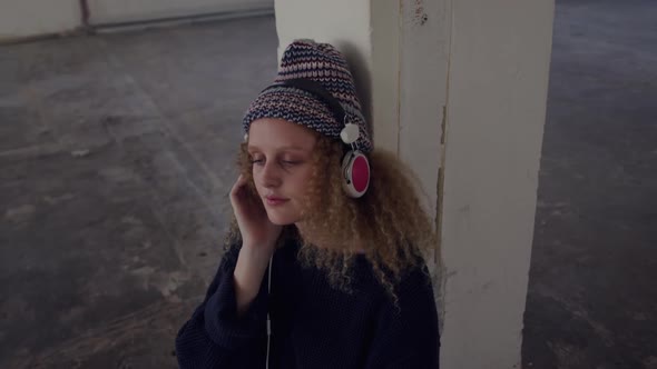 Fashionable young woman in an abandoned warehouse