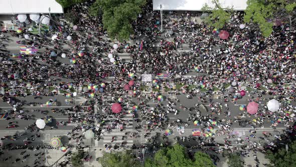 aerial drone shot of a diverse crowd walking during mexico city's pride parade on paseo de la reform