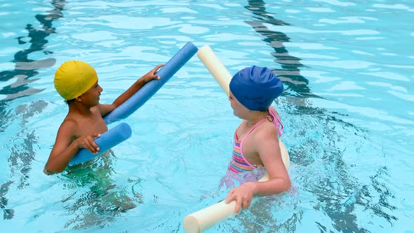 Kids swimming with noodle floater