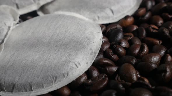 Filter coffee pods on top of roasted  beans 4K footage