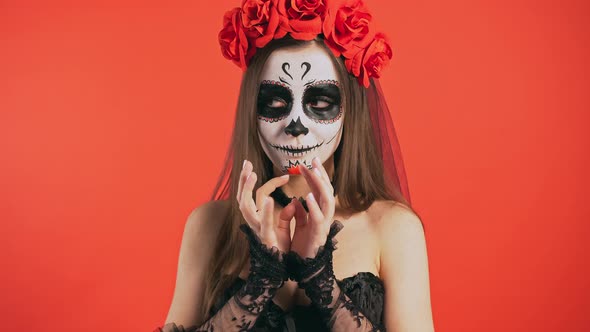 Day of Dead Female with Sugar Skull Makeup is Acting Like Waiting for Something Looking Around and