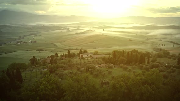 Flying over the foggy Tuscany Italy landscape