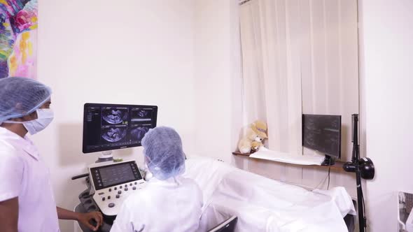 Indian Mother Nurse And Ultrasound Operator Viewing Her Baby