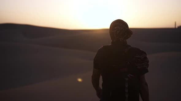 Man Standing In Sunlit Desert