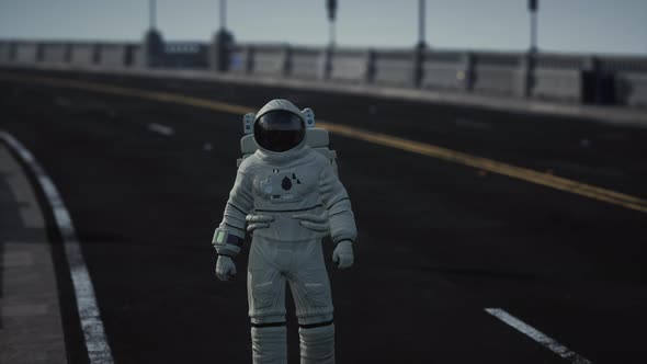 Astronaut Walks in the Middle of a Road