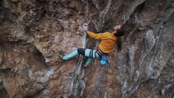 Strong Man Rock Climber Climbing Overhanging Rock Route Making Hard Move and Falling