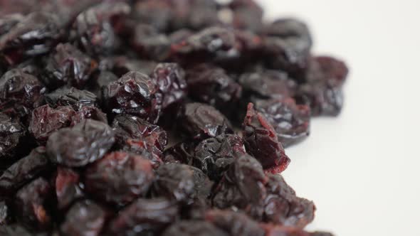Pile of dehydrated cranberries slow tilt 4K 2160p 30fps UltraHD footage - Vaccinium oxycoccos dried 