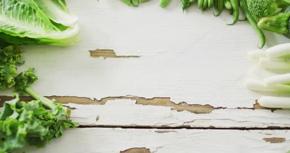 Video of fresh salad leaves with copy space on white rustic background