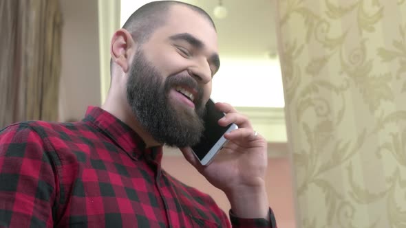 Cheerful Bearded Man with Phone