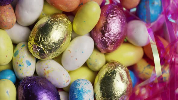 Rotating shot of colorful Easter candies on a bed of easter grass - EASTER 